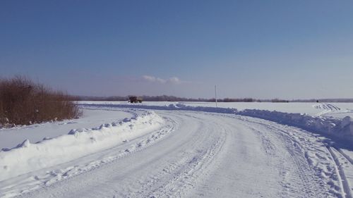 Snow covered field against sky