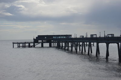 Pier over sea against sky