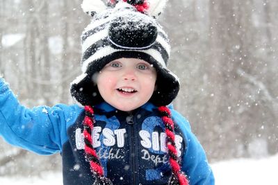 Portrait of young woman standing on snow