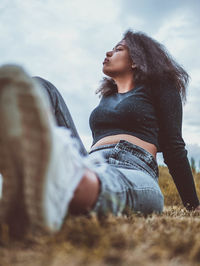 Low angle view of woman looking away