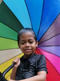 Portrait of smiling boy holding umbrella