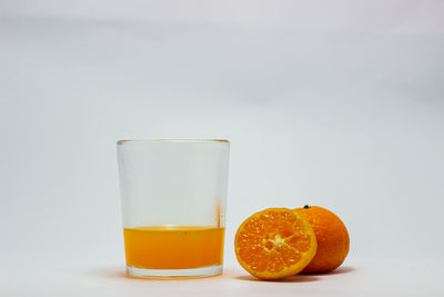 Close-up of orange juice against white background