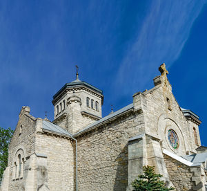 Old stone church of early 20th century on a background of blue sky