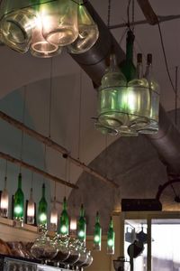 Low angle view of illuminated pendant light hanging in restaurant