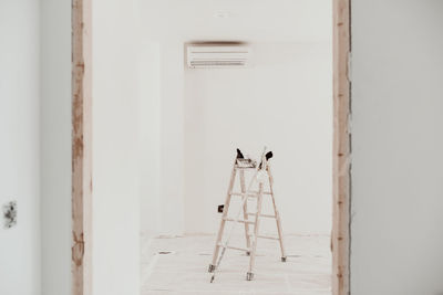 Ladder on white room at construction site. painting walls. home improvement, renovation