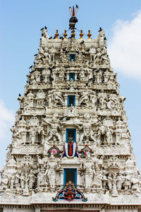 Low angle view of statues on building against sky