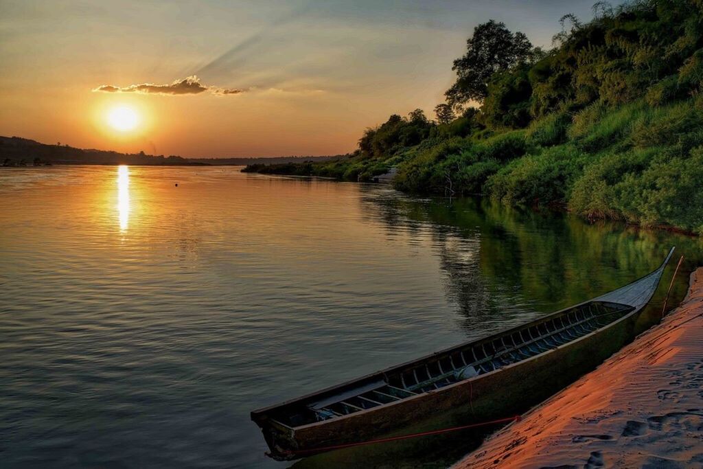 water, sunset, reflection, transportation, nautical vessel, scenics, tranquil scene, boat, sun, mode of transport, river, tranquility, rippled, sky, beauty in nature, waterfront, nature, sea, non-urban scene, outdoors, cloud - sky, water surface, tourism, no people, vacations