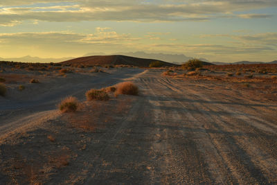 Scenic view of desert against sky during sunset