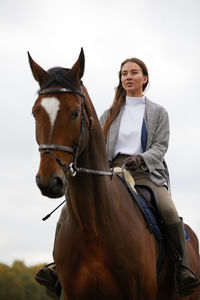 Portrait of woman riding horse