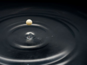 High angle view of drop splashing in water