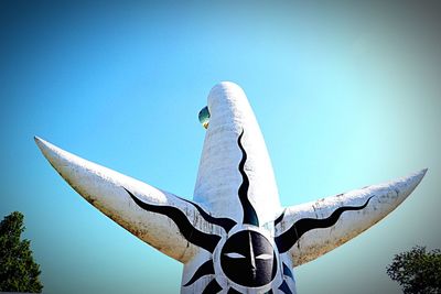 Low angle view of statue against clear blue sky