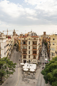 High angle view of street amidst buildings against sky