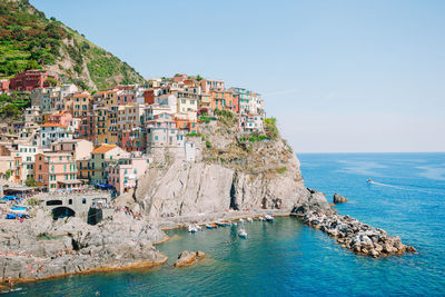 Scenic view of beach by city against sky