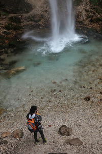 High angle view of man surfing on rocks