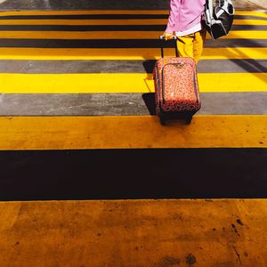 Low section of woman walking on road