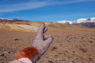 Close-up of woman hand with mountain in background