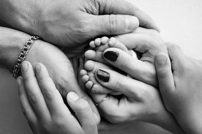 Cropped image of couple holding hands