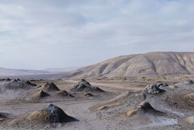 Scenic view of arid landscape against sky