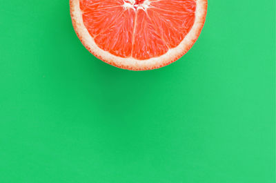 Close-up of orange slice over white background