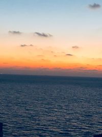 Scenic view of sea against romantic sky at sunset