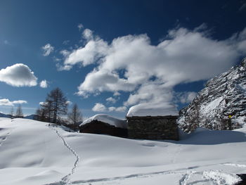 Snow covered landscape against sky