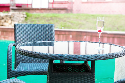 Empty chairs and tables at swimming pool