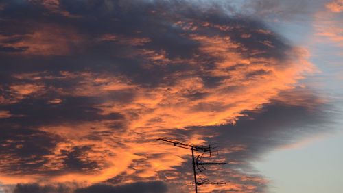 Silhouette antenna against sky during sunset