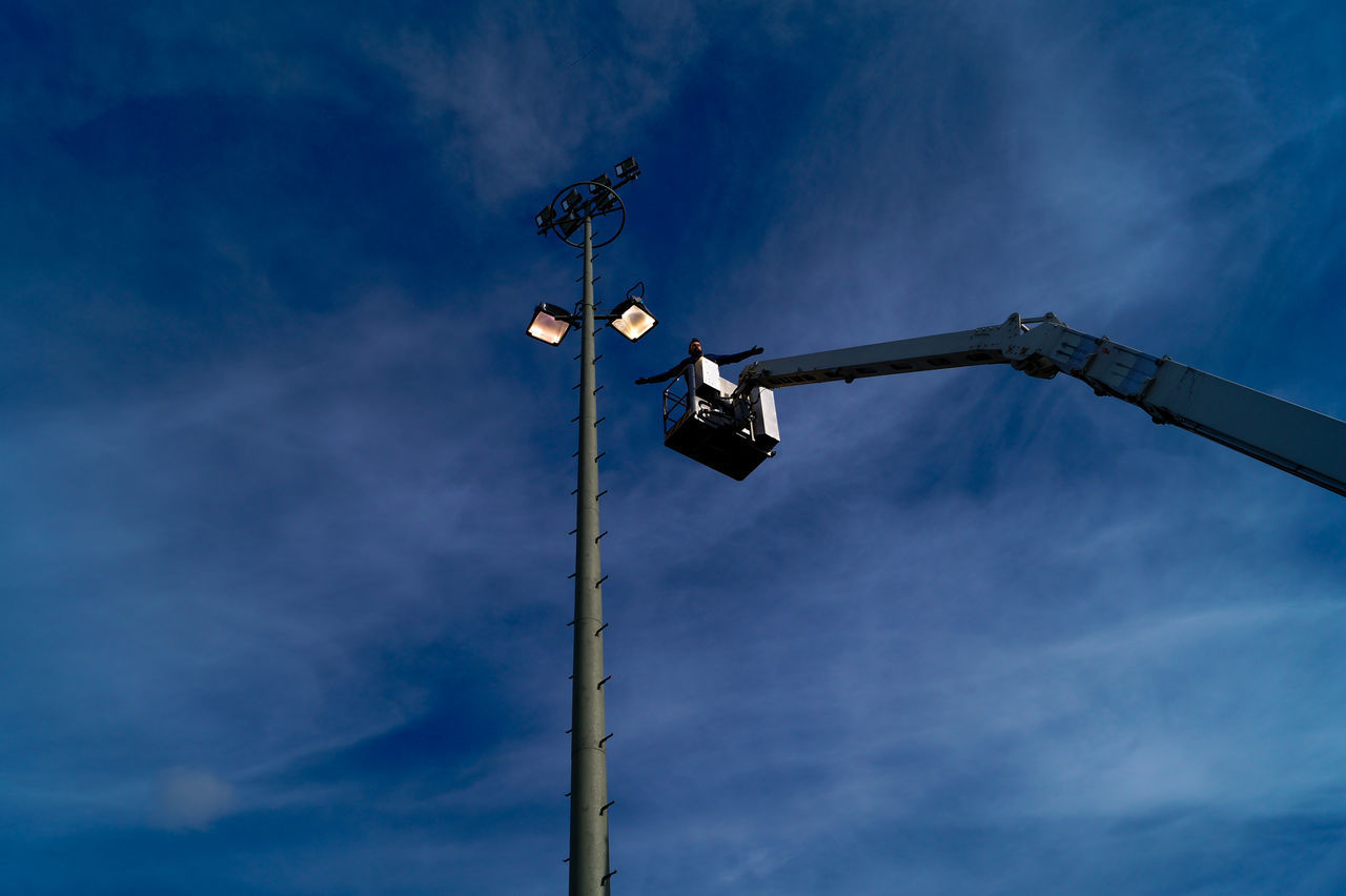 LOW ANGLE VIEW OF ILLUMINATED STREET LIGHT AGAINST BLUE SKY