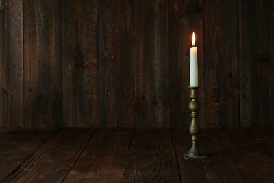 Illuminated lamp on wooden floor