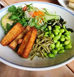 High angle view of chopped vegetables in plate on table