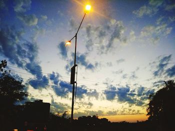 Low angle view of silhouette street light against sky