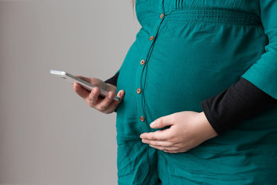 Midsection of man using mobile phone