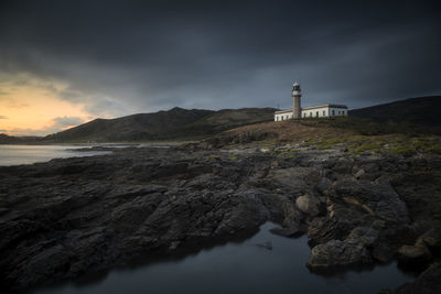 Lonely lighthouse on the coast at sunset