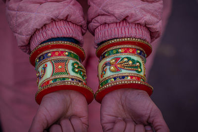 Cropped hands of woman showing bangles