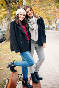 Portrait of smiling young woman standing outdoors