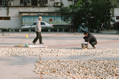 Full length of boy playing in city