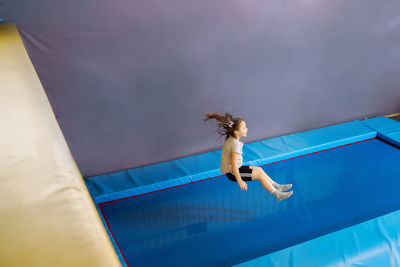 Full length rear view of woman in swimming pool