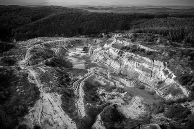 Aerial shot of abandoned opencast mine. abstract cracked mud pattern from a drone. black and white