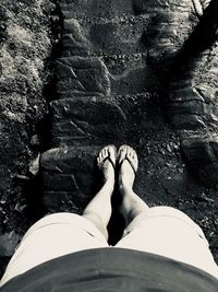 Low section of woman standing on rock