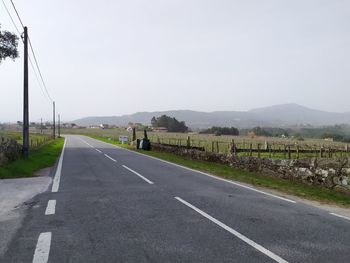 Road by mountain against clear sky