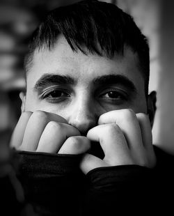 Close-up portrait of teenage girl covering face