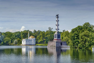 Built structure by lake against sky