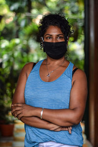 Interior portrait of woman wearing a face mask