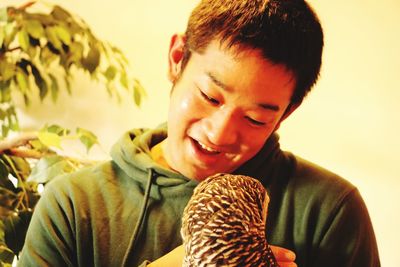 Smiling young man with bird