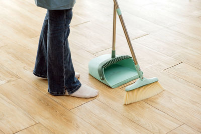 Low section of man standing on hardwood floor