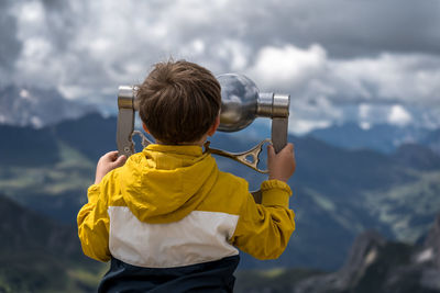 Rear view of man standing against sky