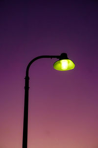 Low angle view of illuminated street light against sky