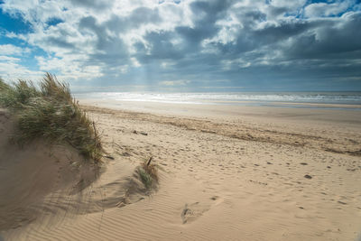 Scenic view of beach against sky