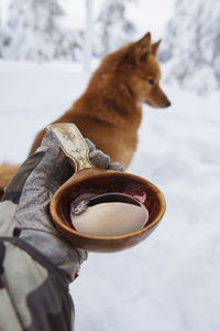 Hand holding wooden cup