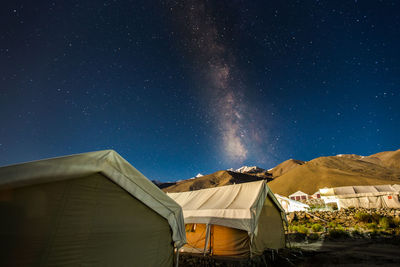 Houses against sky at night